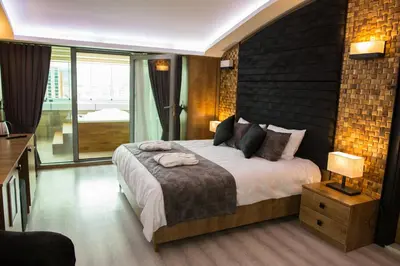 a bedroom with a large bed and a large window at Hotel BFC Spa & Sport in Bursa