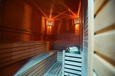 an empty wooden sauna with lights on the ceiling at Hotel BFC Spa & Sport in Bursa