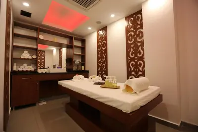 a bathroom with a bed and a sink and a mirror at Hotel BFC Spa & Sport in Bursa