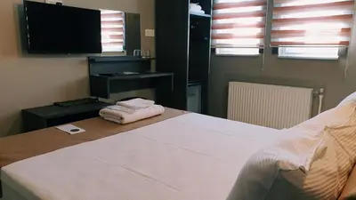 a bedroom with a bed with two folded towels on it at Royal Park Hotel Corlu Bed and Breakfast in Tekirdag