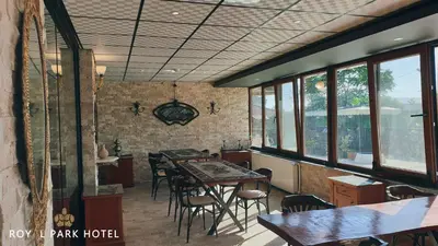 a dining room with a table and chairs and windows at Royal Park Hotel Corlu Bed and Breakfast in Tekirdag