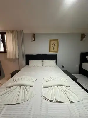 a large white bed with two pillows on it at AWWA APART HOTEL in Istanbul