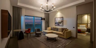 a living room with a couch and a table at Hilton Mall Of Istanbul in Istanbul