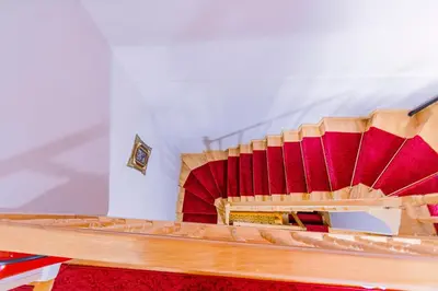 a wooden staircase with red seats in a room at Acacia Mansion Hotel in Istanbul