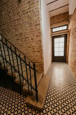 an empty room with a staircase and a brick wall at Galadoo Suites in Istanbul