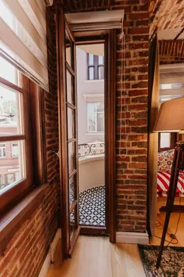 an open door in a room with a brick wall at Galadoo Suites in Istanbul