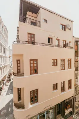 an apartment building with a balcony on a street at Galadoo Suites in Istanbul