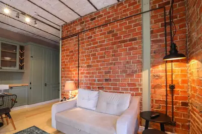 a brick wall with a couch in a living room at Galadoo Suites in Istanbul