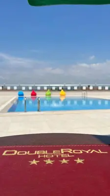 a swimming pool with a red rug with stars on it at DOUBLE ROYAL HOTEL in Kocaeli