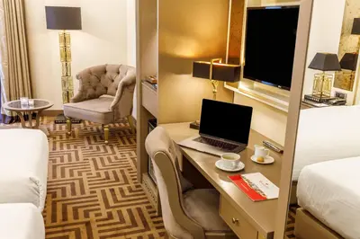 a hotel room with a desk with a laptop and a chair at Ramada by Wyndham Istanbul Golden Horn in Istanbul