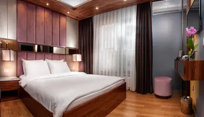 a bedroom with a large bed and a window at Vitabella Suites in Istanbul