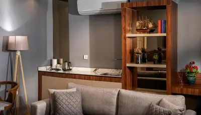 a living room with a couch and a mirror at Vitabella Suites in Istanbul