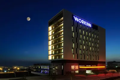 a night view of a hotel with a sign on it at Workinn Hotel in Gebze