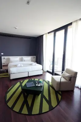 a bedroom with a bed and a couch and a table at Workinn Hotel in Gebze