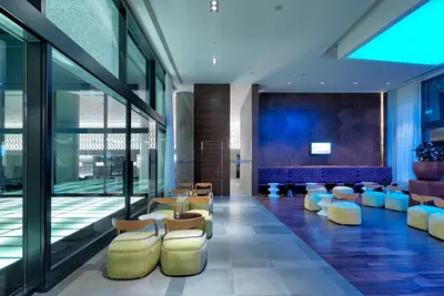 a lobby with chairs and tables in a building at Workinn Hotel in Gebze