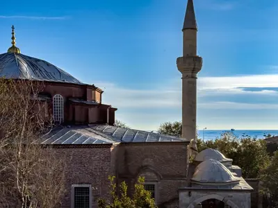 an old mosque with a minaret in front of it at Antik Konak Little Hagia Sophia Suites in Istanbul