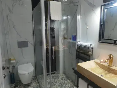 a bathroom with a shower and a toilet and a sink at The Independent Hotel Taksim in Istanbul