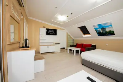 a hotel room with a bed and a desk at GRAND VATAN HOTEL in Istanbul