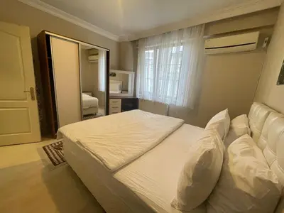 a bedroom with a large white bed and a window at Apart Point in Istanbul