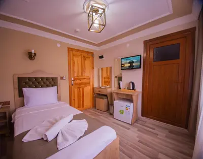 a bedroom with a bed with towels on it at Hotel Orkide in Istanbul