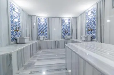 a bathroom with three sinks and blue and white tiles at Mardia Hotel in Istanbul