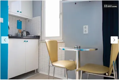 a small kitchen with two chairs and a table at Blue Apartment in Istanbul