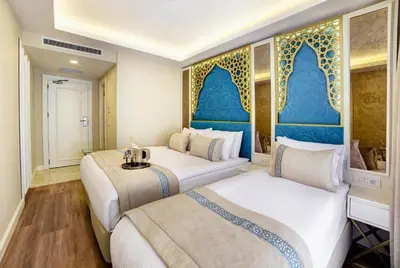 two beds in a room with blue and white at Great Fortune Design Hotel & Spa in Istanbul