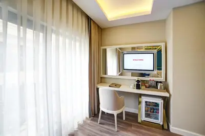 a room with a desk with a television and a chair at Great Fortune Design Hotel & Spa in Istanbul