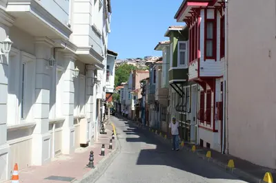 a person walking down a street between buildings at Ararat Apart in Istanbul