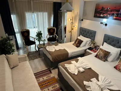 a hotel room with two beds and a couch at Galapera Hotel in Istanbul