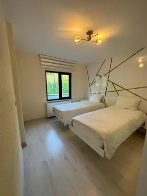 a bedroom with two beds and a window at Golden Hour Apartment بورصة شقة مريحة Bursa Nilufer مَنْظَرٌ جَمِيلٌ in Nilüfer