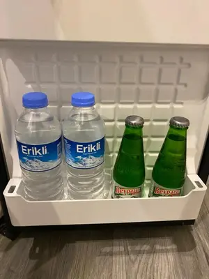 three bottles of water in an open refrigerator at Siesta Premium Hotel in Istanbul
