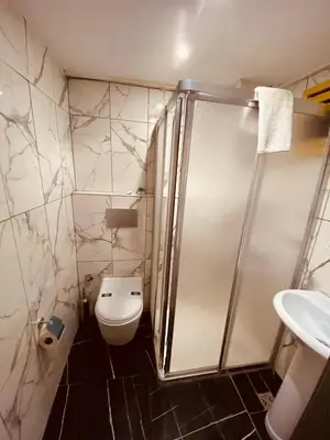 a bathroom with a shower and a toilet and a sink at Siesta Premium Hotel in Istanbul