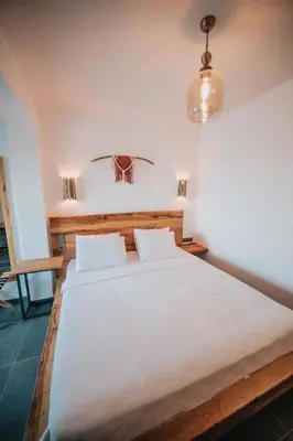 a bedroom with a large white bed with two pillows at Büyükada Loc'ada in Adalar
