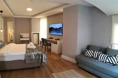 a bedroom with a bed and a desk and a couch at Galata Door Hotel in Istanbul