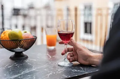 a person holding a glass of wine next to a bowl of fruit at Galata Door Hotel in Istanbul