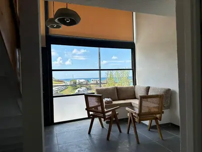 a living room with a couch and chairs and a large window at Sahil Kamp İstanbul Hotel in Sile
