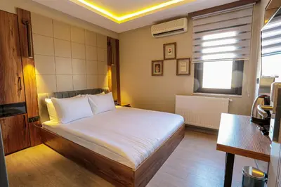 a bedroom with a bed and a window at Arach Hotel Harbiye in Istanbul