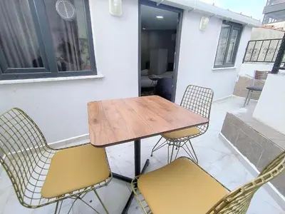 a wooden table and chairs on a patio at King Istanbul Hotel in Istanbul