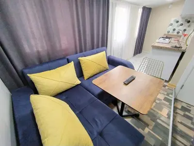 a living room with a blue couch and a wooden table at King Istanbul Hotel in Istanbul