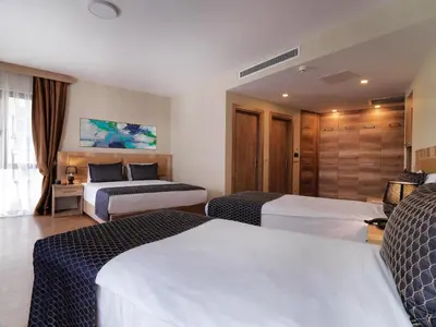 a hotel room with two beds and a window at Jaff Hotels & Spa Nisantasi in Istanbul