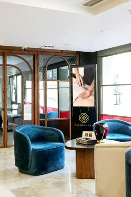 a living room with two blue chairs and a table at Jaff Hotels & Spa Nisantasi in Istanbul