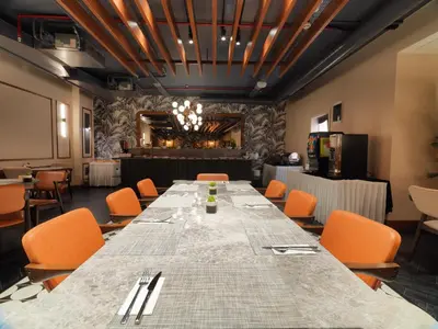 a long table in a room with orange chairs at Jaff Hotels & Spa Nisantasi in Istanbul