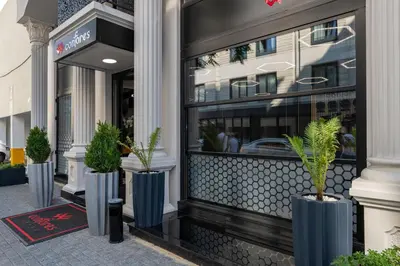 a store front with three blue vases with plants in them at Confores Hotel in Istanbul
