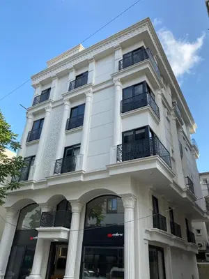 a white building with columns and balconies at Confores Hotel in Istanbul