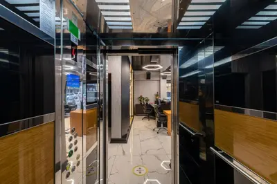 an office corridor with a glass door leading into a room at Confores Hotel in Istanbul