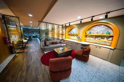 a living room with a couch and a table and chairs at İstport Hotels in Arnavutköy