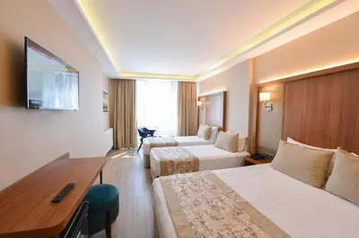 a hotel room with two beds and a desk at İstport Hotels in Arnavutköy