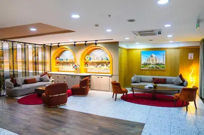 a lobby with two couches and a table and chairs at İstport Hotels in Arnavutköy