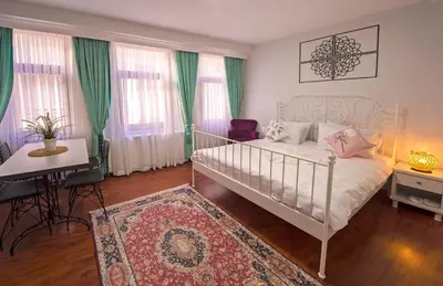a bedroom with a bed and a table and a desk at Duru Istanbul Apart in Istanbul